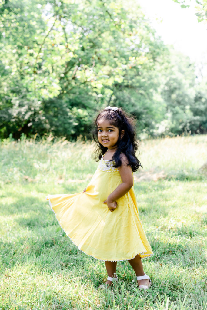 Girl twirling in her dress taken by Mallorie Miller Photography 